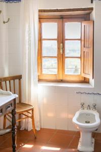 a bathroom with a toilet and a window at Palazzo Ninci in Civitella in Val di Chiana