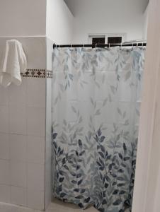 a shower curtain with a blue and white pattern at Maos flats in Cartagena de Indias