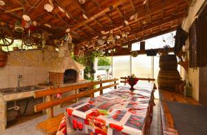 a kitchen with a table and a stove in it at Apartment Davor 2330 in Pula