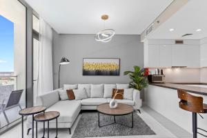 a living room with a couch and a table at Premium 1-BR with Exquisite Layout in District One in Dubai