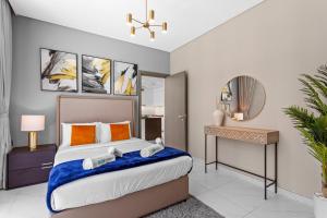 a bedroom with a large bed and a desk at Premium 1-BR with Exquisite Layout in District One in Dubai