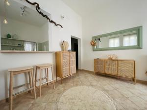 a living room with two stools and a mirror at Casa Sasa in Porto Cesareo +15 photos