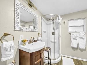 a bathroom with a sink and a shower at Family Tides Steps to beach and bay in Bradenton Beach