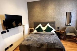 a bedroom with a bed and a tv and a chair at Relax in Duisburg