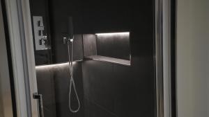 a shower in a bathroom with a mirror at Diana's luxury guest house in Padova +17 photos