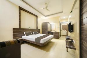 1 dormitorio con 1 cama y TV en Collection O Hotel Silver Inn, en Bhopal