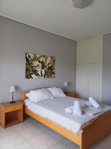 a bedroom with a bed with two towels on it at Aktaion apartments in Artemísion