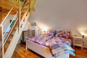a bedroom with a bed and a staircase at Naturhäusle Oberschwaben in Ebersbach-Musbach