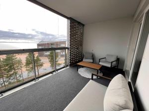 Una sala de estar con un sofá y una ventana grande. en Jäkälänhovin Huippu, en Kalajoki