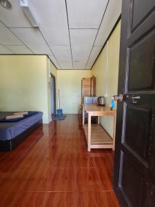 a living room with a couch and a table at Rainbow Tioman Cottage in Kampong Juara