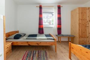 a bedroom with a bed and a window with curtains at Apartments Bor in Bohinj