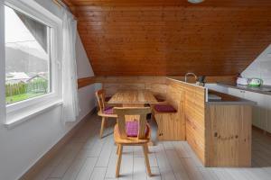 a small kitchen with a table and a table and chairs at Apartments Bor in Bohinj +30 photos