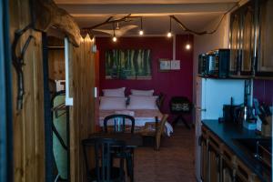 eine Küche mit einem Zimmer mit einem Bett in der Unterkunft Les Hébergements au Dy-Na in Petite Île