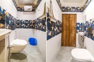 uma casa de banho com paredes em azulejos azuis e brancos e um WC. em FabHotel Roadside Inn em Naksalbāri