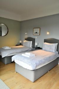 two beds sitting in a room with at Bowood Park Hotel in Camelford