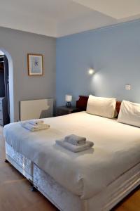 a bedroom with a large bed with two towels on it at Bowood Park Hotel in Camelford