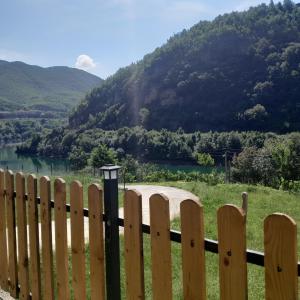 valla de madera con vistas al río en Guest House Artjon en Fierzë