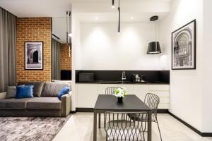 a living room with a couch and a table at OLD TOWN SNAIL Design Apartments in Bucharest