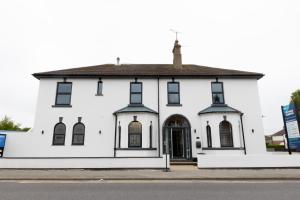 a white building with a black roof at Victoria Apartments in Skegness