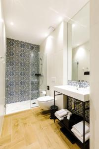 a bathroom with a sink and a toilet and a shower at OLD TOWN SNAIL Design Apartments in Bucharest +51 photos