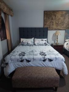 a bedroom with a bed with a black and white comforter at Maison plaza in Arequipa