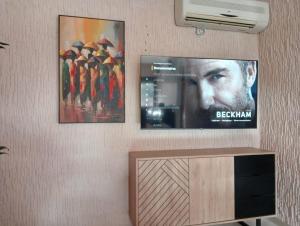 two posters of a movie on a wall with a tv at Babylone Marrakech in Marrakech