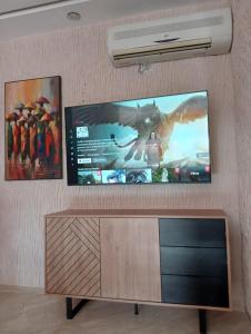 a flat screen tv hanging on a wall at Babylone Marrakech in Marrakech