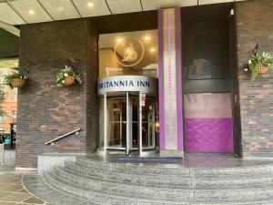 a building with a staircase in front of a building at Britannia Inn Glasgow in Glasgow