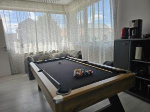 a billiard table in a living room with a couch at Family Vila Oravita in Oraviţa
