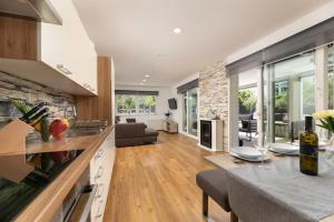 cocina y sala de estar con pared de piedra en Villa Novum, en Malinska
