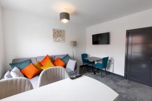 a living room with a couch and a table at Victoria Apartments in Skegness
