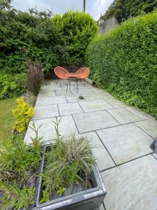 a patio with a bench and some plants at No.18 Holmfirth in Holmfirth