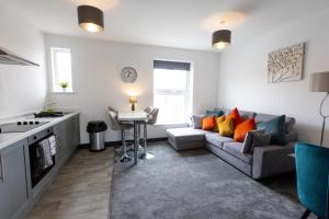 a living room with a couch and a table at Victoria Apartments in Skegness