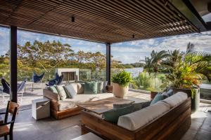 a living room with a view of the water at Penthouse Luxueux avec Piscines, Vues Mer et Montagne in Rivière Noire