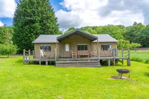 a cabin in a field with a green yard at Teal - Exton Park in Exton
