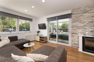 Una sala de estar con un sofá y una chimenea. en Villa Novum, en Malinska