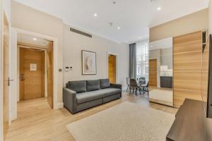 a living room with a couch and a table at Cleveland Residences Chelsea in London