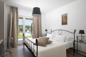 a white bedroom with a bed and a large window at Villa Jana in Rovinj +18 photos