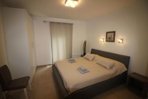 a bedroom with a bed with two towels on it at Apartment Umag in Umag