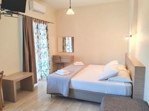 A bed or beds in a room at Angelica Studios and Apartments