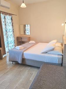 A bed or beds in a room at Angelica Studios and Apartments