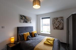 a bedroom with a bed with a lion picture on the wall at Victoria Apartments in Skegness