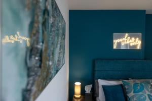 a bedroom with a bed with a green accent wall at Victoria Apartments in Skegness