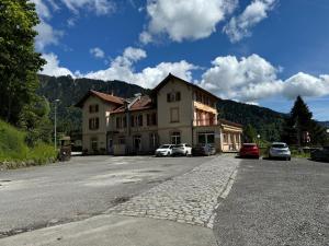 a building with cars parked on the side of a road at Buffet de la gare 