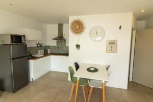 a kitchen with a table and a clock on the wall at coté verdon 2 in Quinson