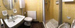 a bathroom with a sink and a toilet and a shower at Casa Natura in Cernobbio