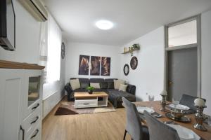 a living room with a couch and a table at Stan Stari Grad Budva in Budva