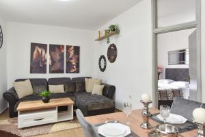 a living room with a couch and a table at Stan Stari Grad Budva in Budva +17 photos