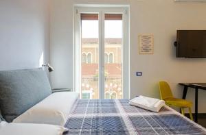 サレルノにあるB&B Un Passo Dal Treno Piazza Vittorio Veneto 35のベッドルーム(ベッド1台、窓付)