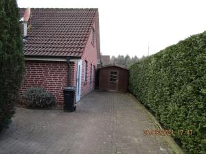 a brick house with a garage and a brick driveway at Waldwiese RE15 in Sögel